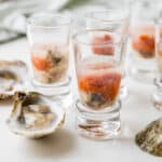 A photo of the oyster shooters with raw oysters in their half shell.