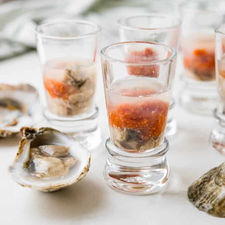 A photo of the oyster shooters with raw oysters in their half shell.