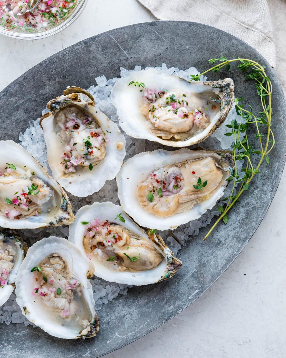 A tray of oysters on the half shell with mignonette.