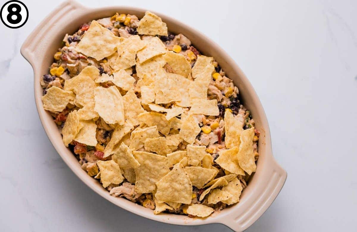 Put the Mexican casserole in a baking dish and top with crushed tortilla chips.