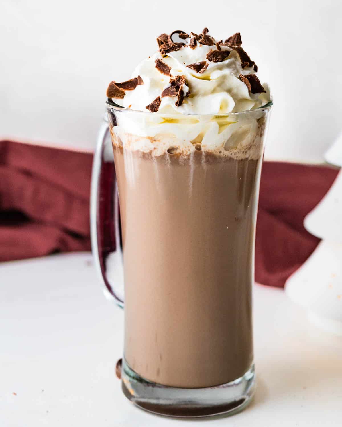 Serving the Bailey's Irish cream coffee in a glass mug with whipped cream and chocolate shavings.