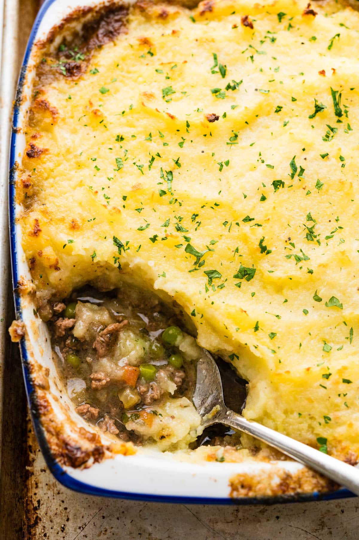 Scooping up the shepherd's pie with gravy and vegetables.