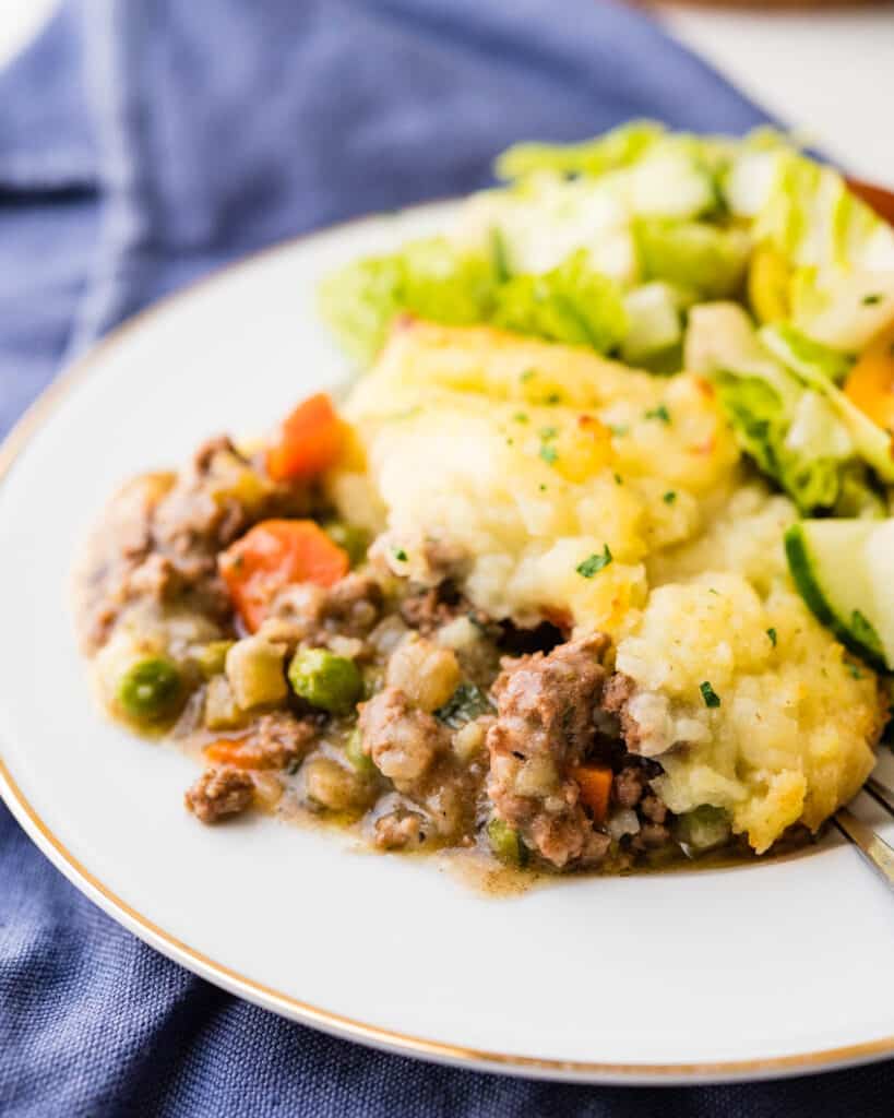 A serving of traditional shepherd's pie on a white plate.