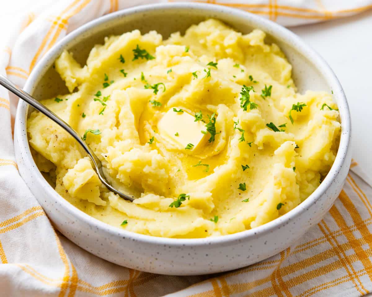 A bowl of riced mashed potatoes.