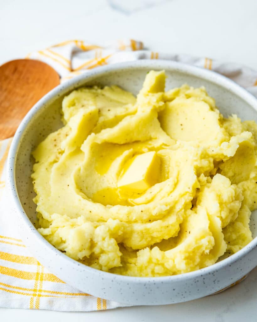 Mashed potatoes with a melting pat of butter.