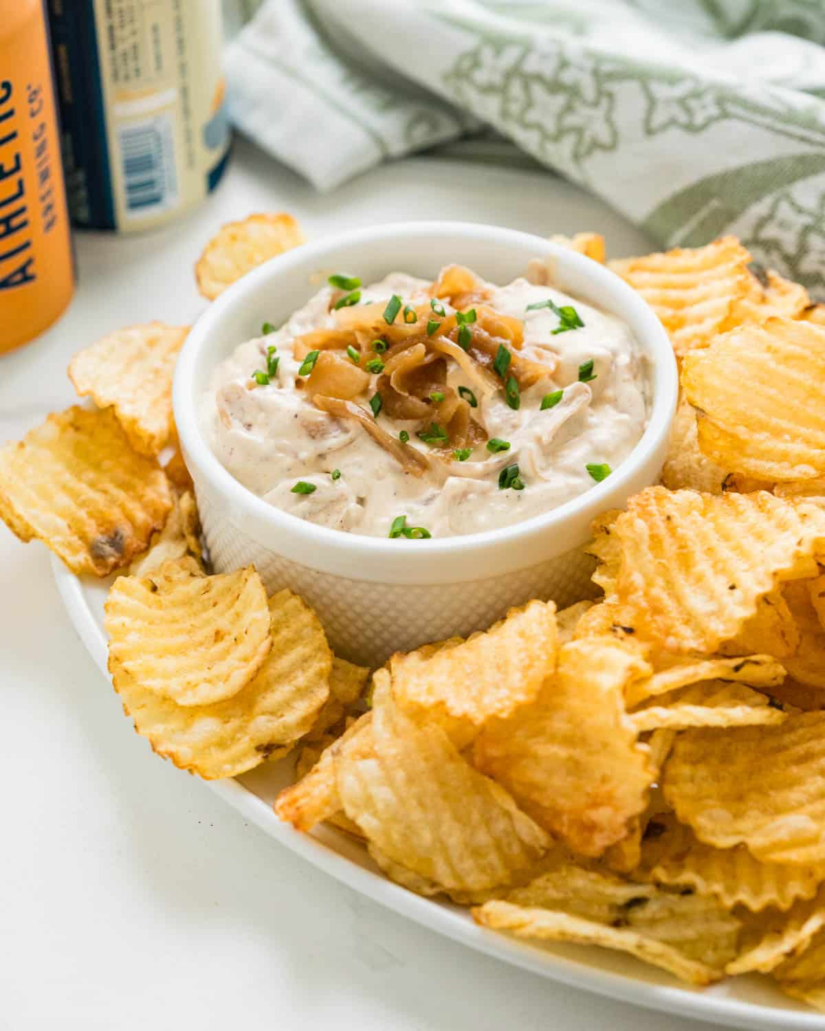 Serving French onion dip with chips on a platter.