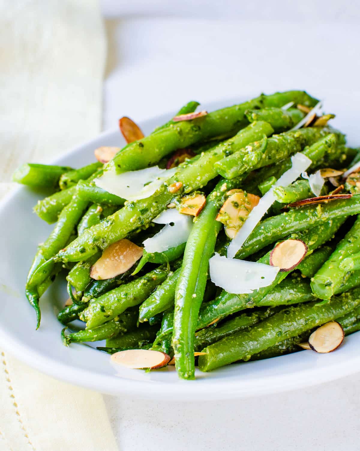 A platter of Italian green beans with almonds and Parmigiano Reggiano.
