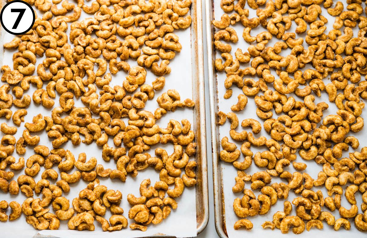 Spreading the curry cashews into an even layer on two baking sheets.