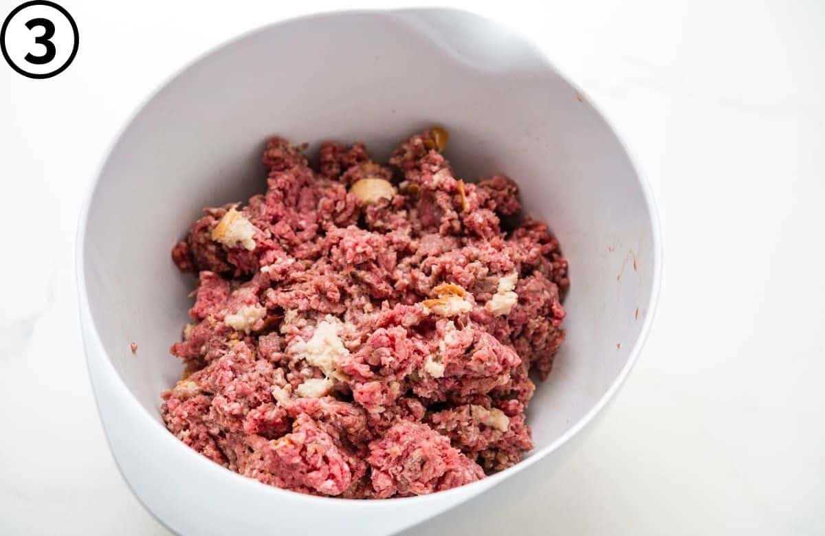 Combining the panade with the ground beef.