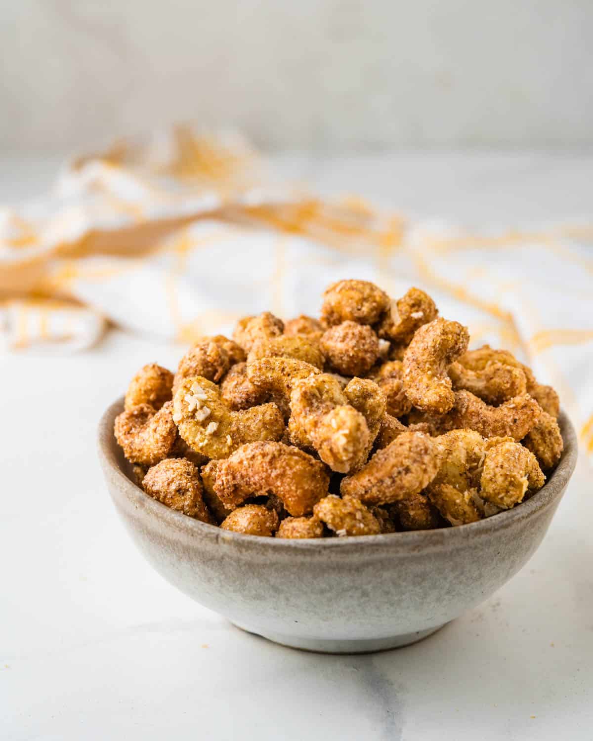 A bowl of roasted coconut cashews.