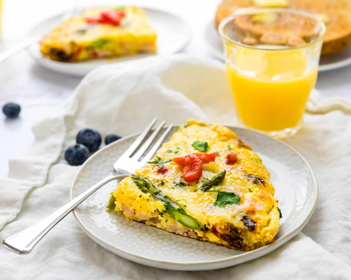 A slice of frittata on a plate. 