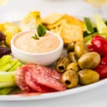 A bowl of roasted bell pepper dip on a veggie platter.