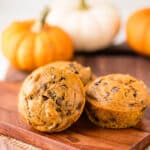 Pumpkin Chocolate Chip Muffins on a cutting board.