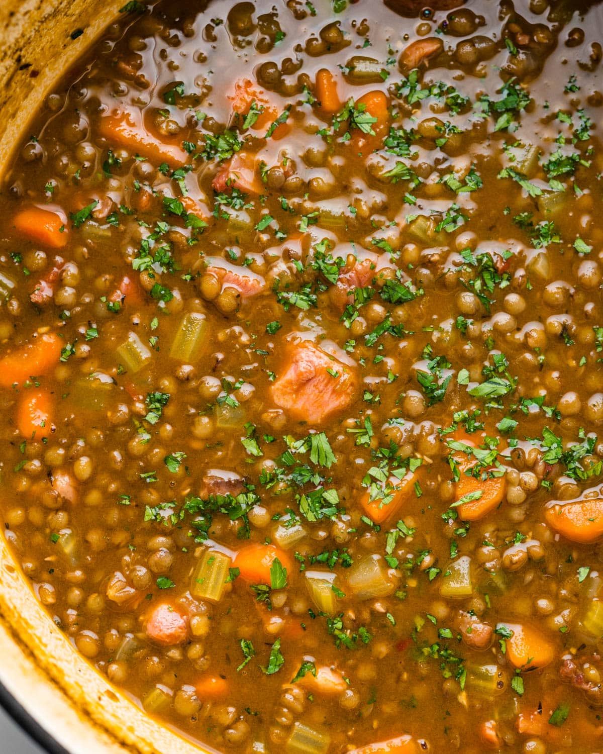 Overhead of the pot of lentil and ham soup.