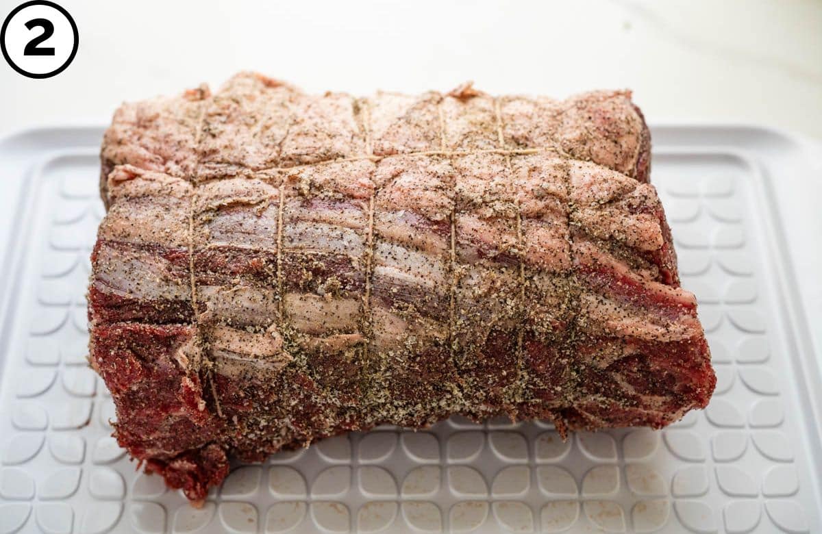 Seasoning the beef with salt and pepper.
