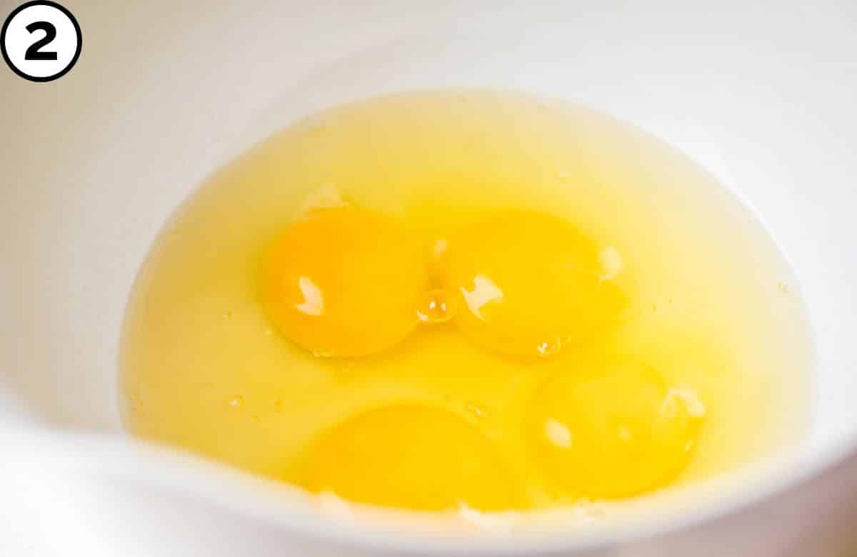 Whisk eggs in a bowl.