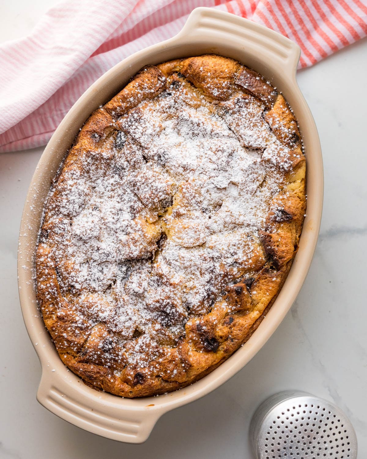Adding powdered sugar to the panettone bread pudding.