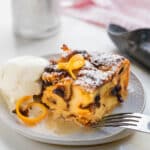 Panettone bread pudding on a plate with ice cream.