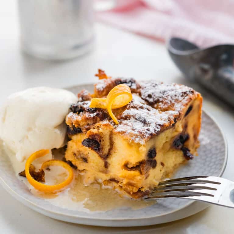Panettone bread pudding on a plate with ice cream.