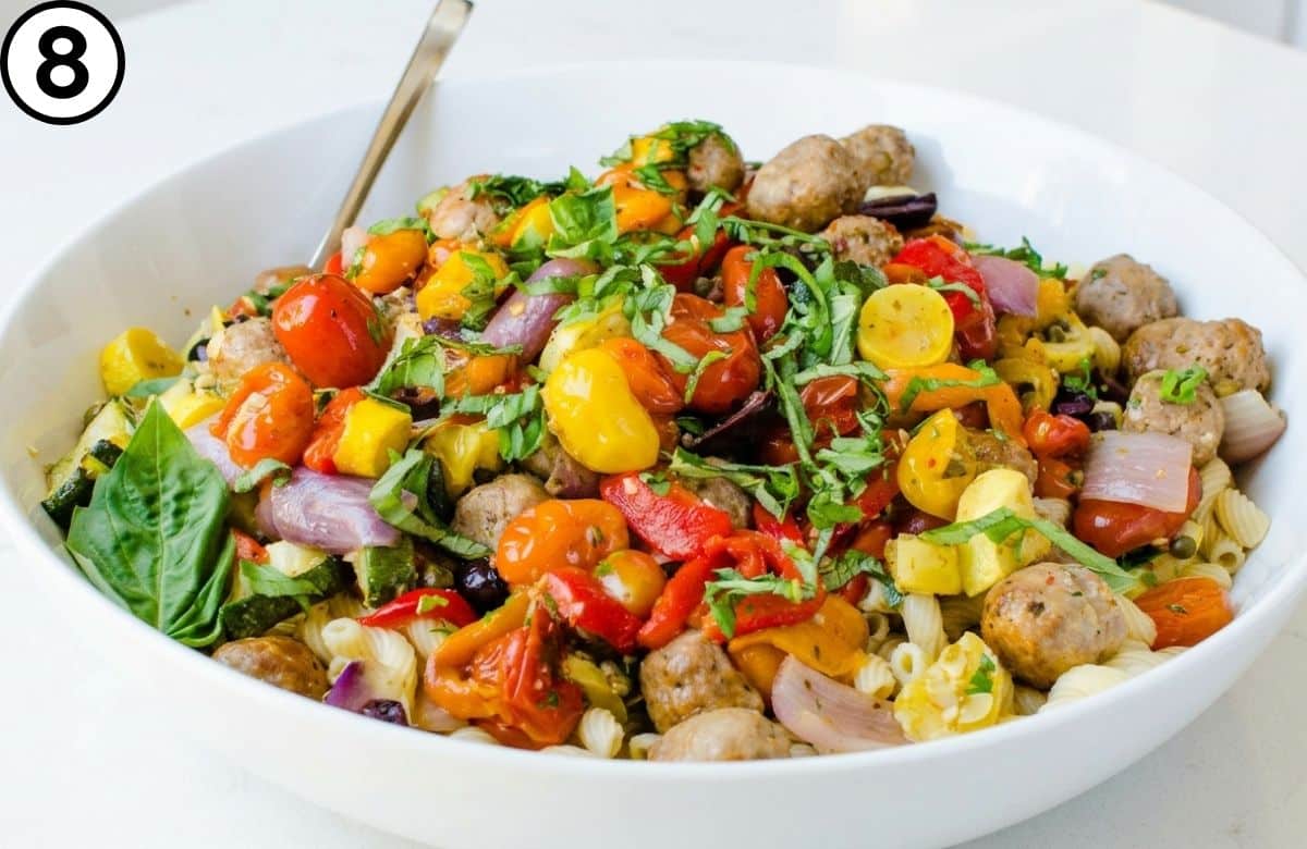 Add the pasta to a large bowl and top with the sausage and peppers.