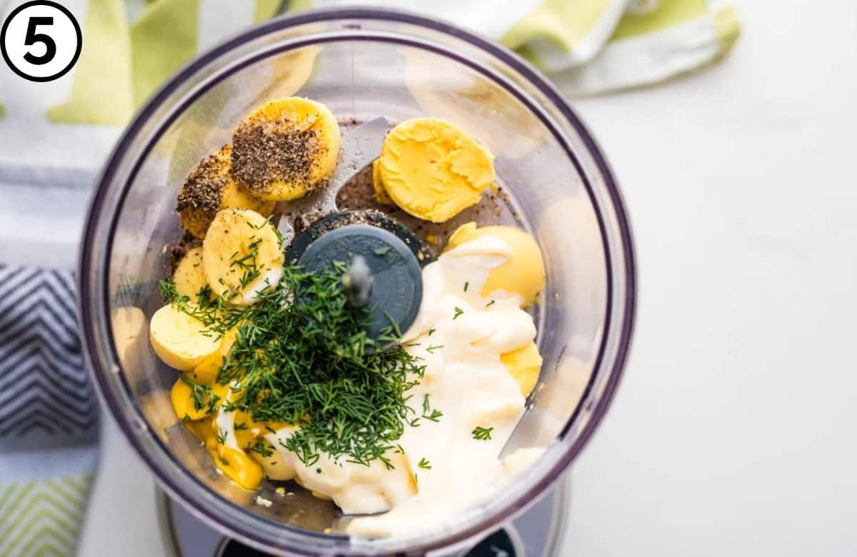 Add the yolks to a food processor.