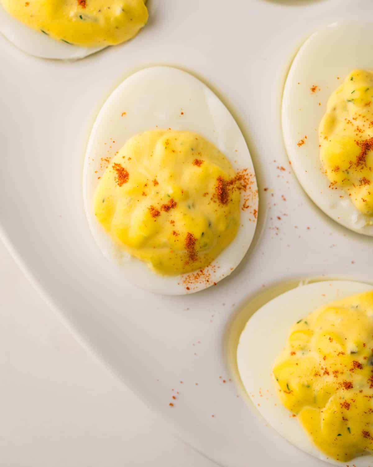 An overhead of the deviled eggs with paprika.