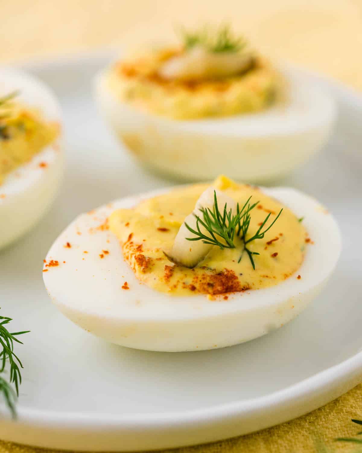 An appetizer plate with 3 dill pickle deviled eggs.