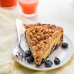A slice of blueberry sour cream coffee cake with cinnamon streusel crumble.