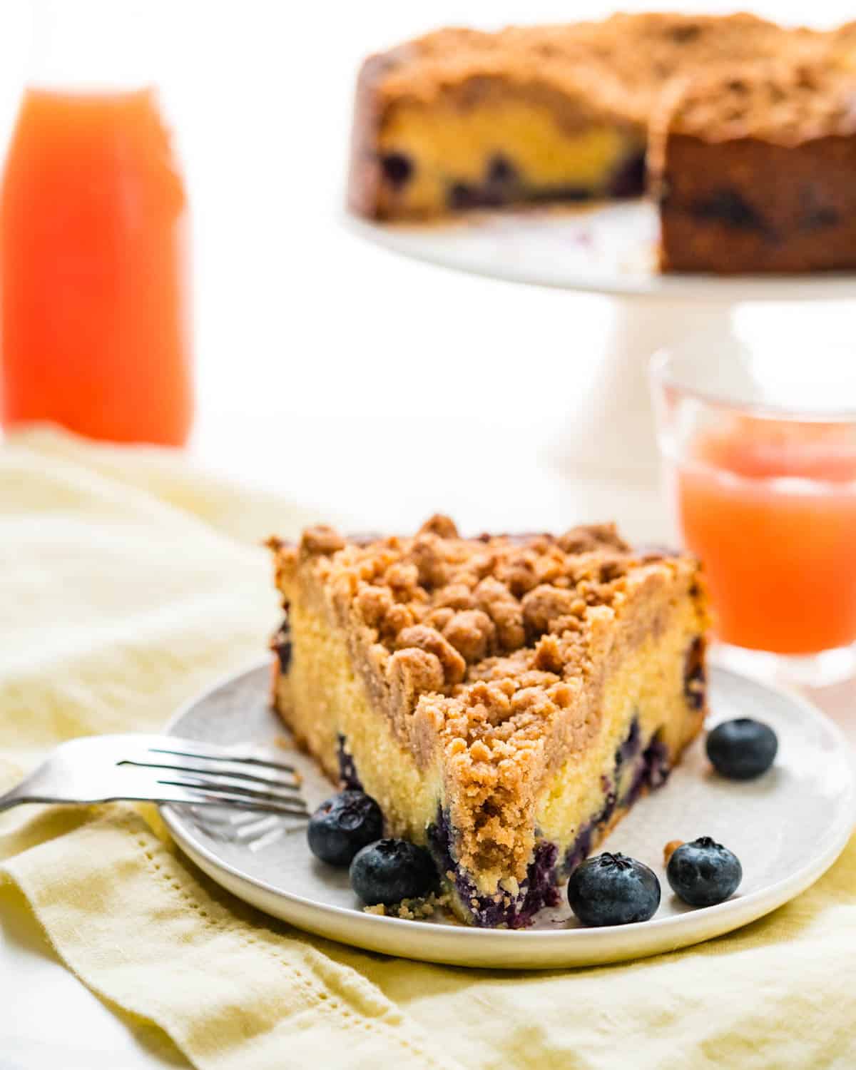 Serving the blueberry coffee cake with extra fruit.