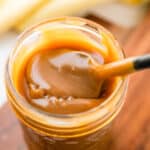 Stirring butterscotch in a glass jar to show the thickness.