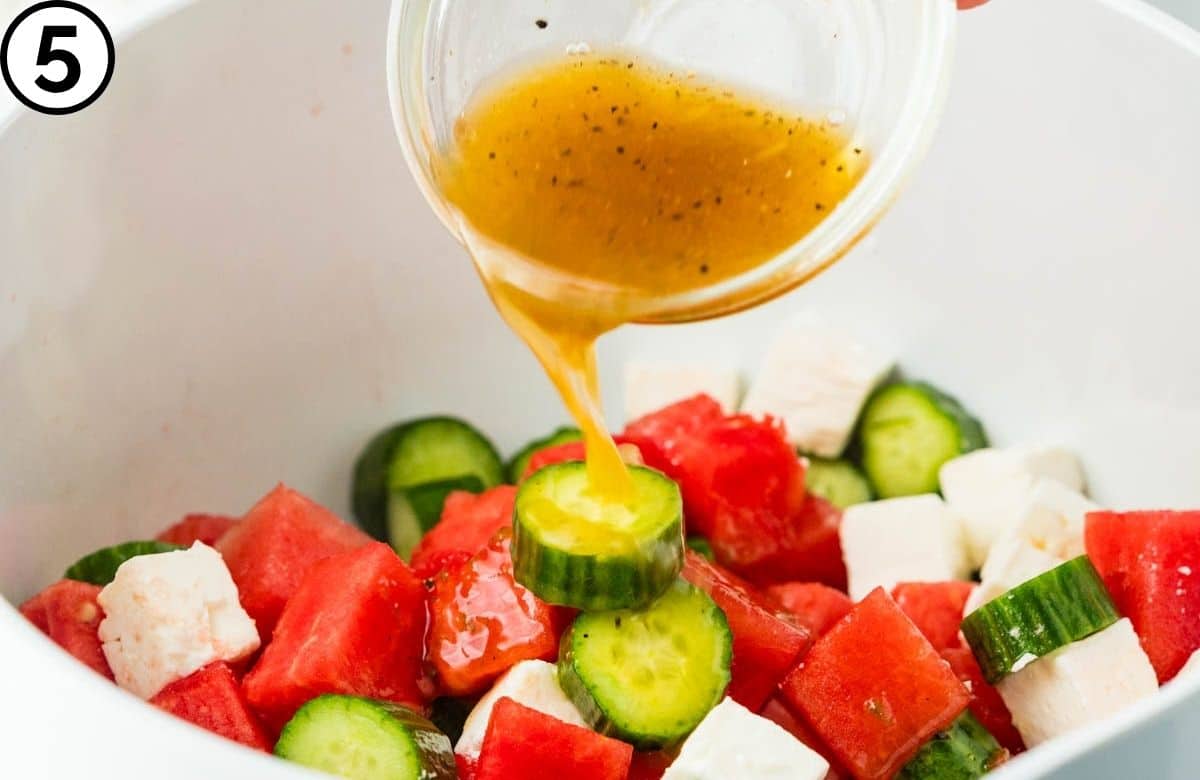 Adding the dressing to the salad.