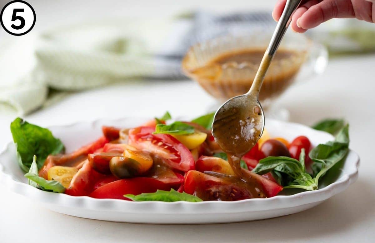 Drizzling balsamic dressing over sliced tomatoes.