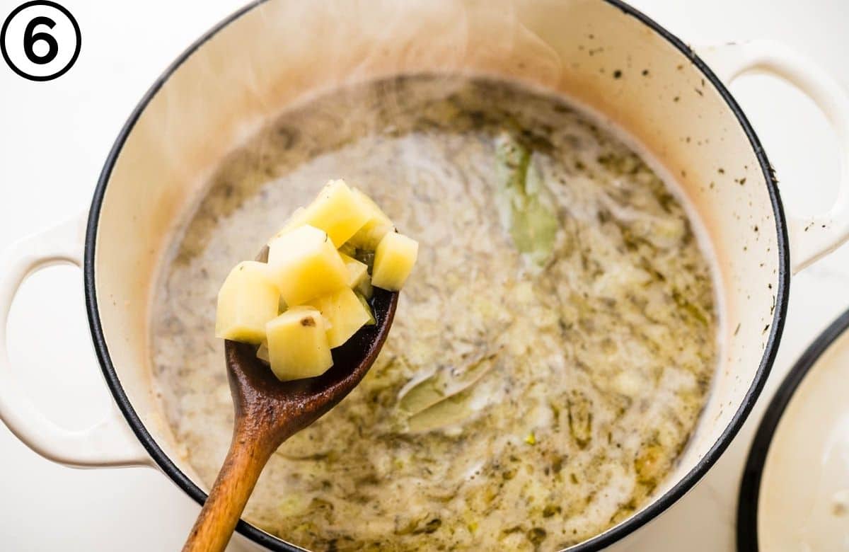 Simmering potatoes in the stock.