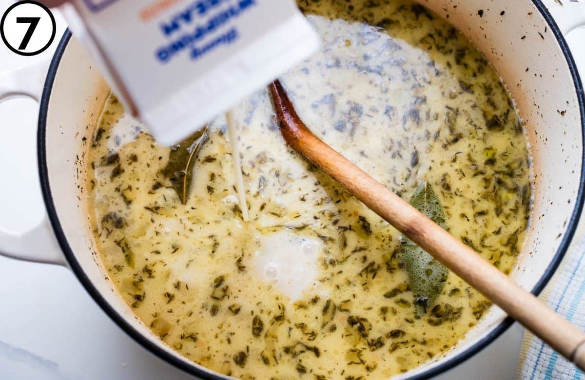 Adding cream to the seafood chowder.