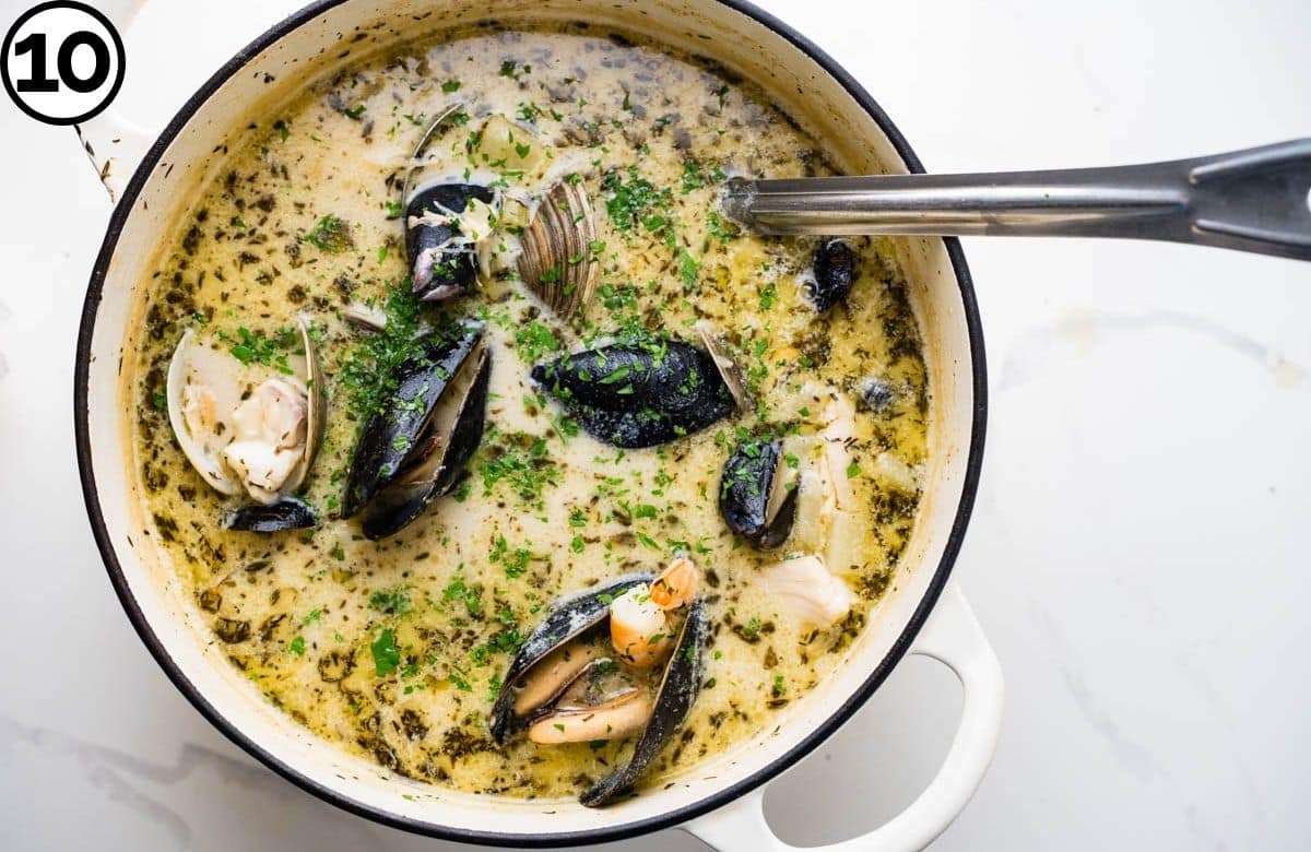 Sprinkling parsley over the chowder.