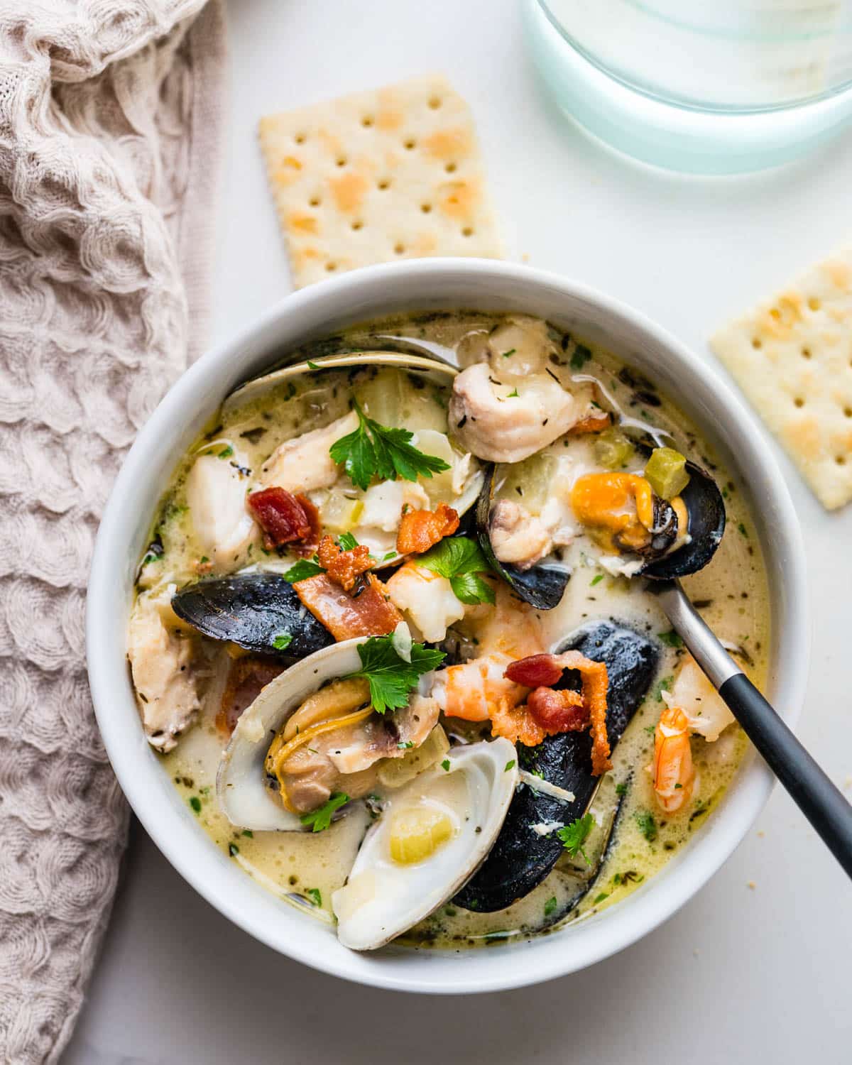 Serving the chowder with saltines.