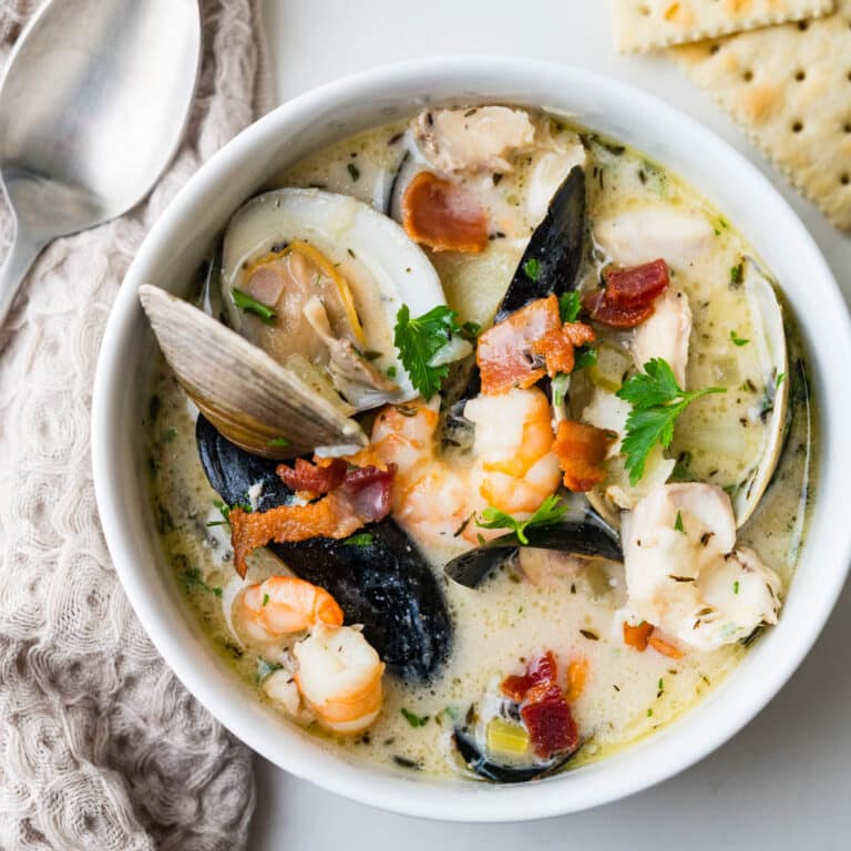 A bowl of seafood chowder with clams, mussels, fish and shrimp.