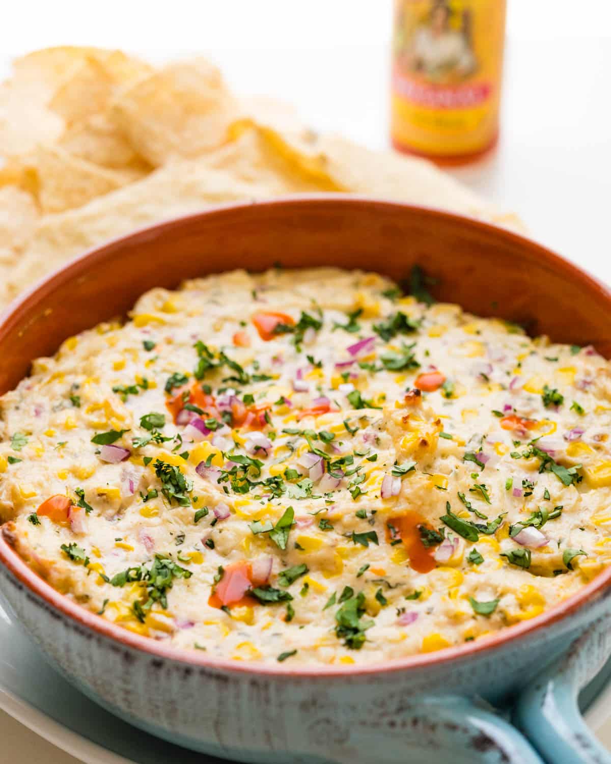 Serving the corn dip with tortilla chips.