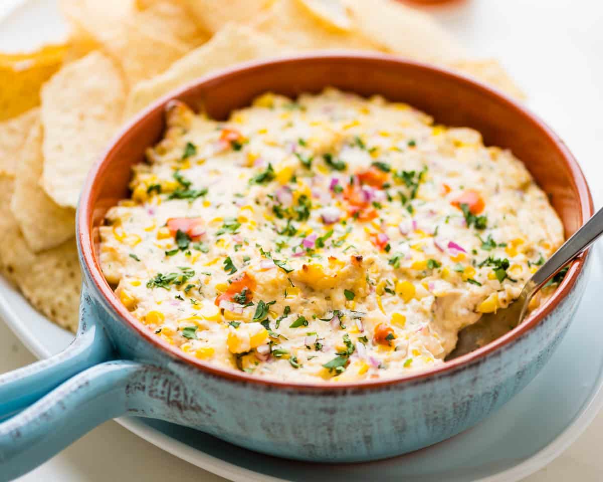 A spoon tucked into the dip for serving.