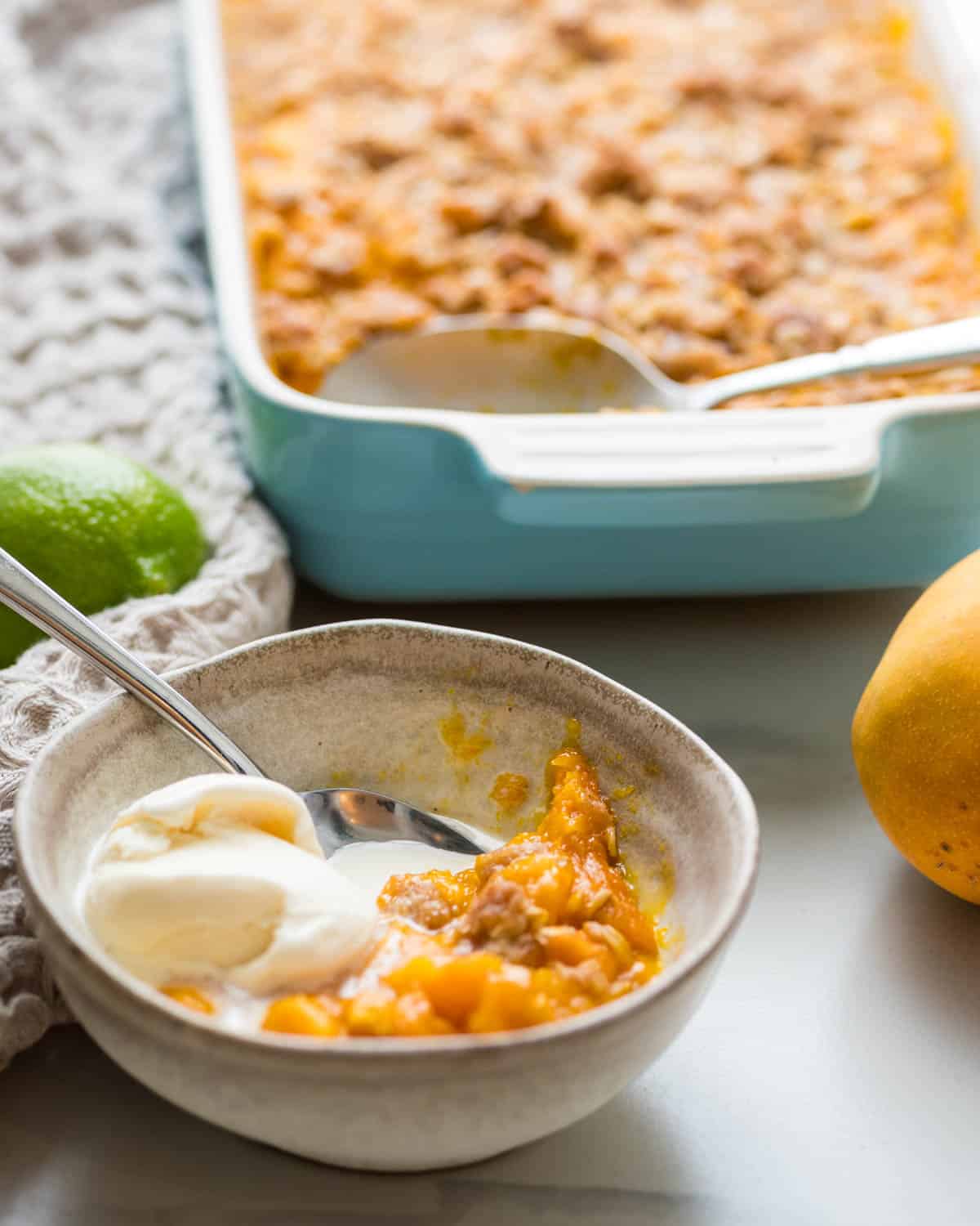Serving the mango crisp with ice cream.