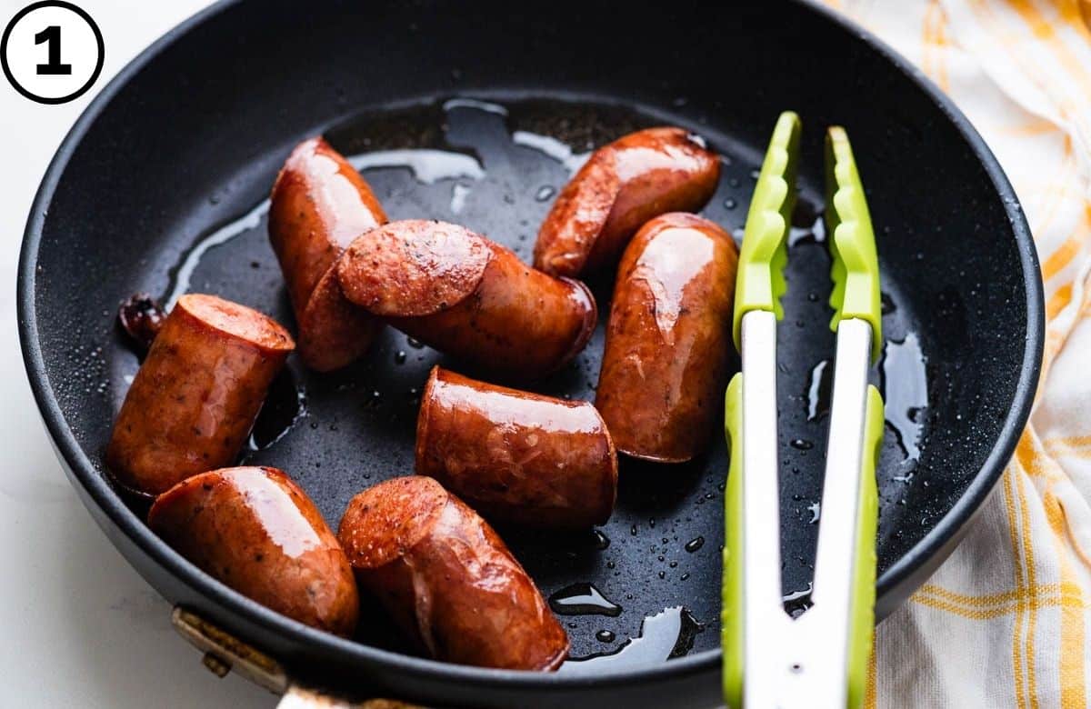 Browning Polish sausage in a skillet.