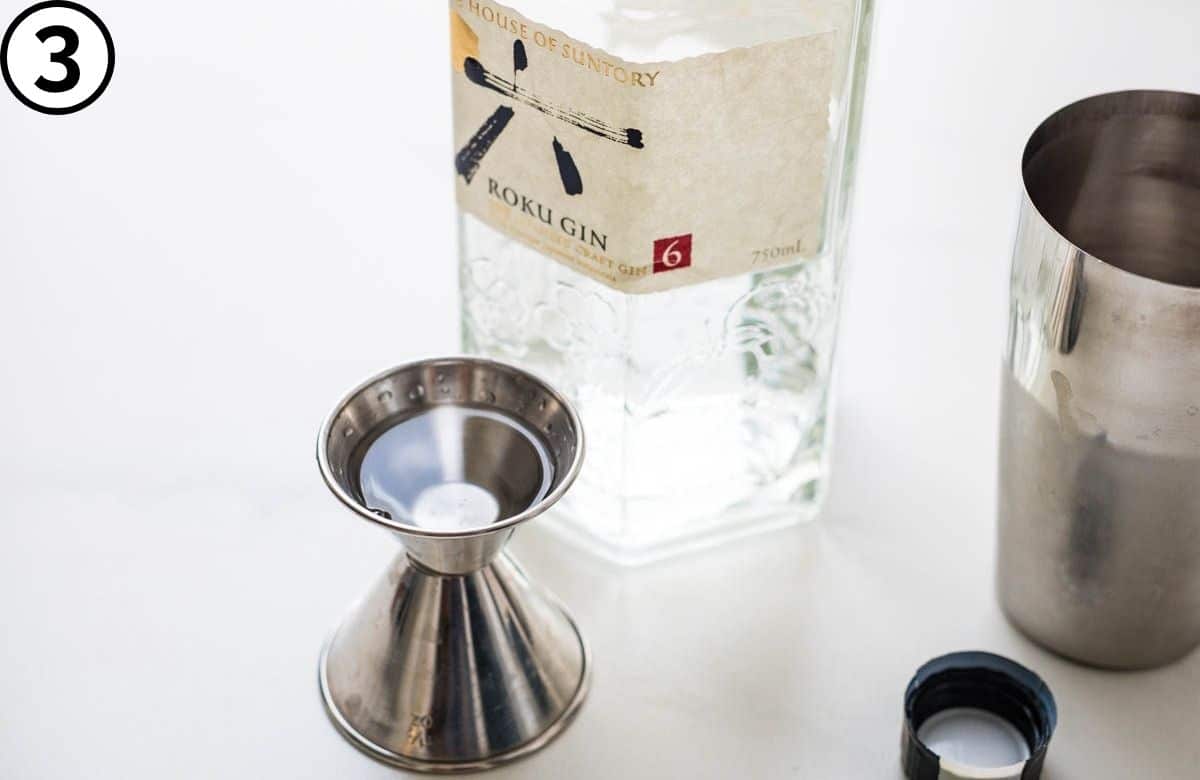 Measuring gin for the 20th century cocktail.