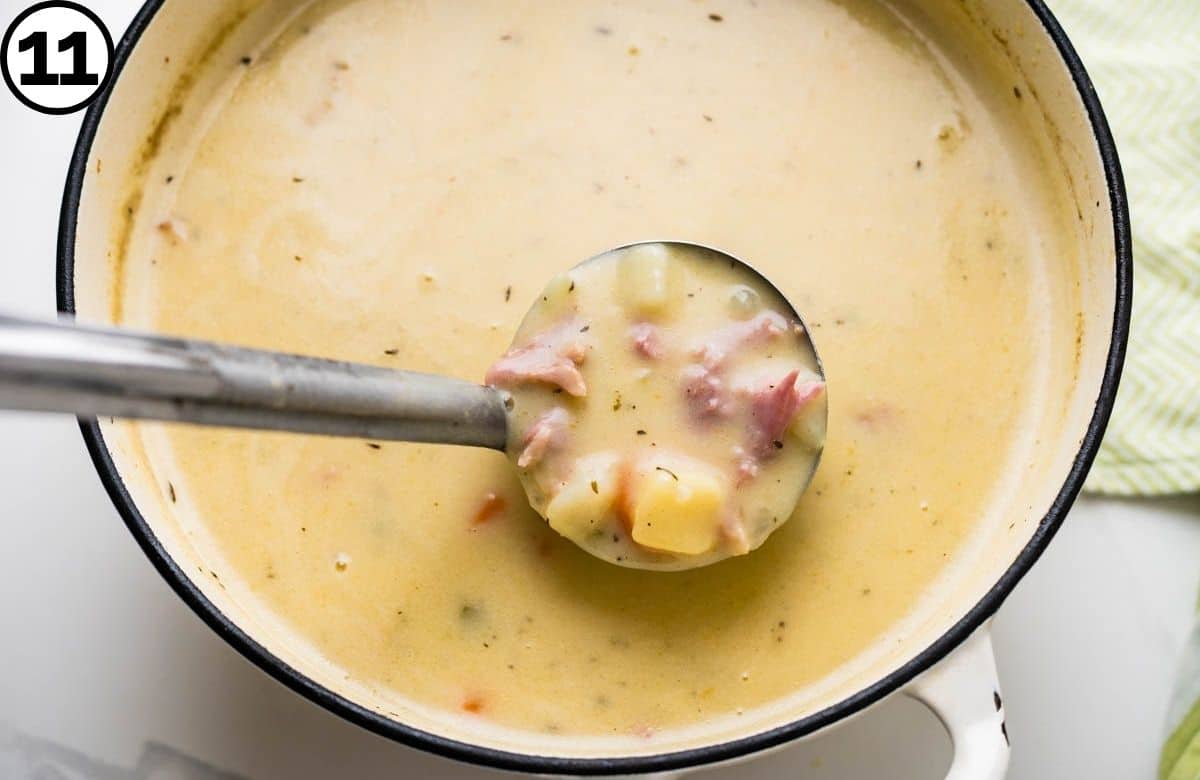 Ladling up a scoop of the ham and potato soup.