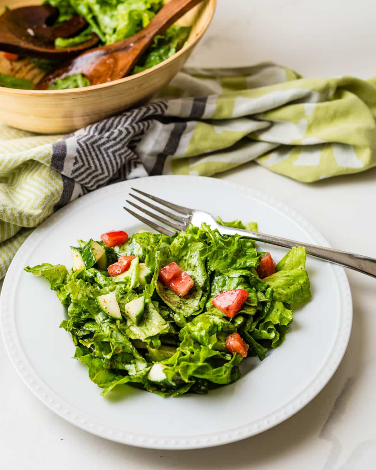 A plate of salad dressed with French red wine vinaigrette.