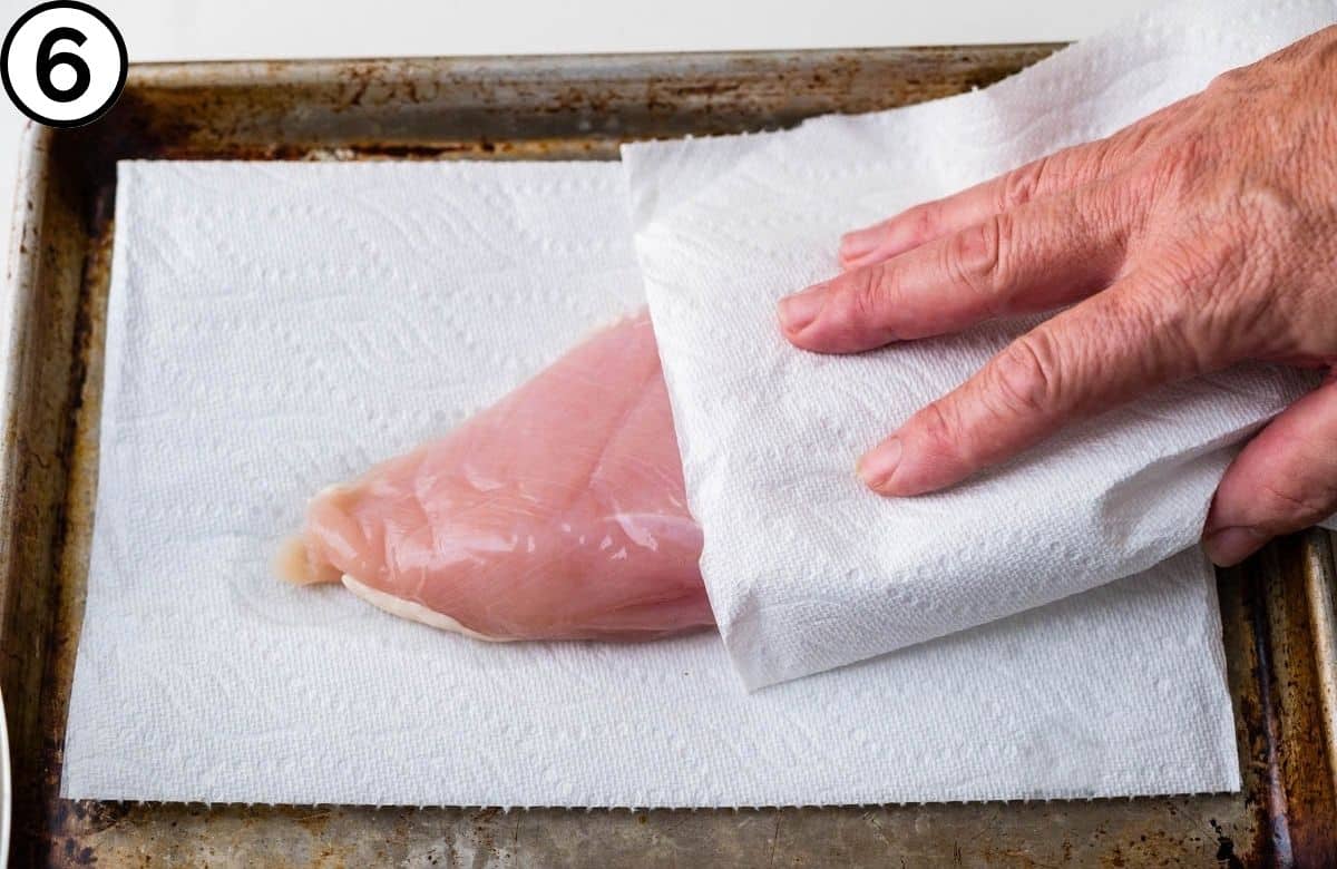 Patting the chicken dry.