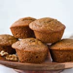 Serving a stack of applesauce muffins on a tray.