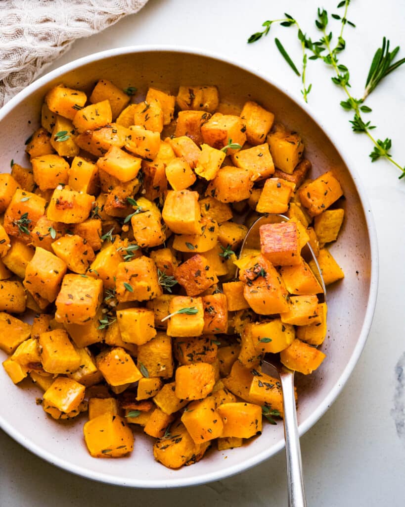 Roasted butternut squash with fresh herbs.