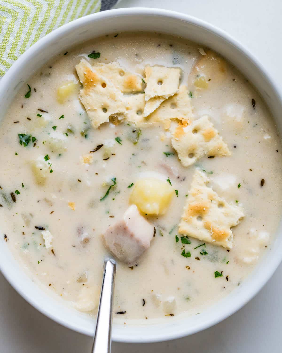 Fish chowder with saltines on top.